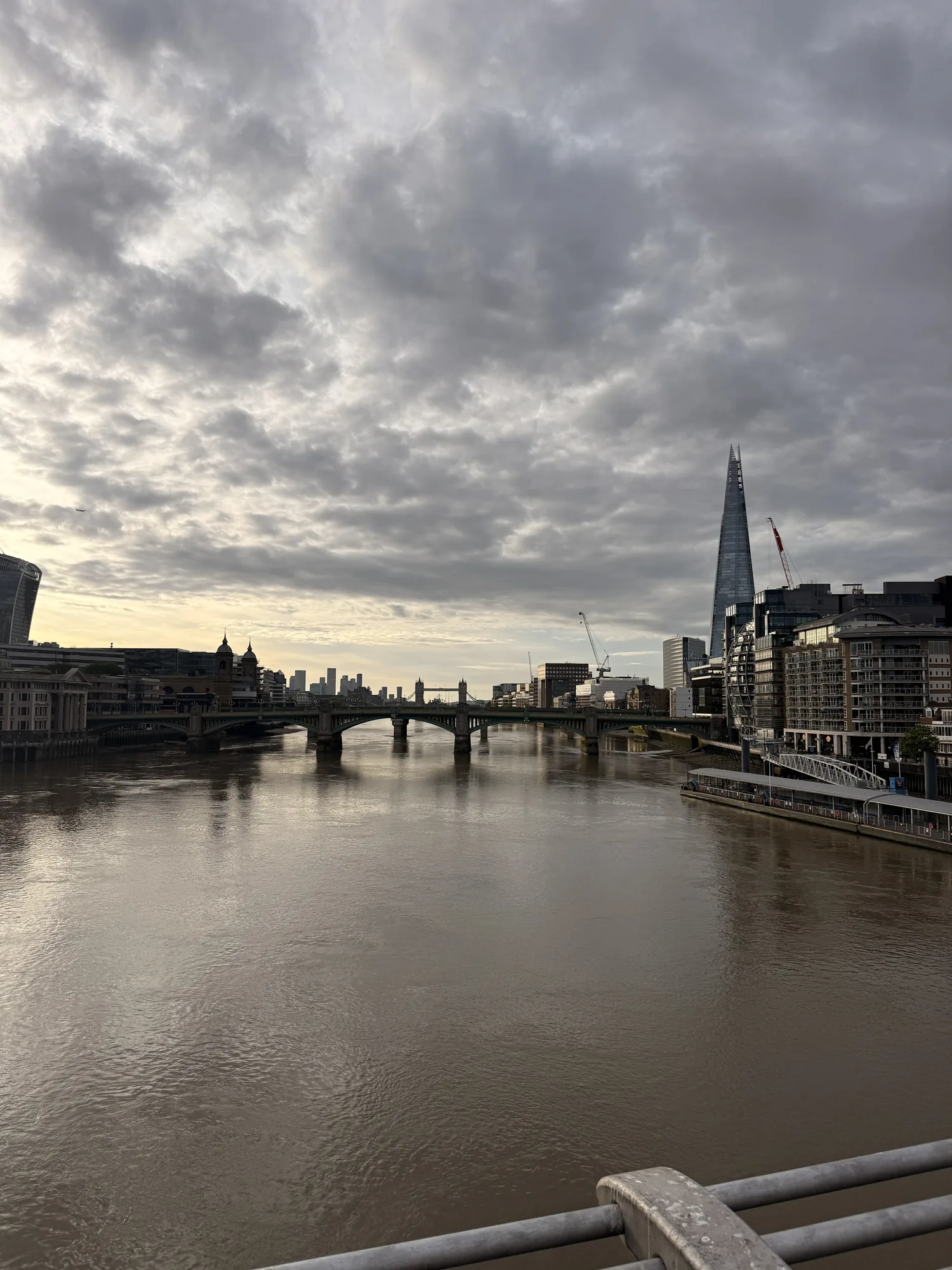 The Thames and London skyline beneath a layered grey sky.