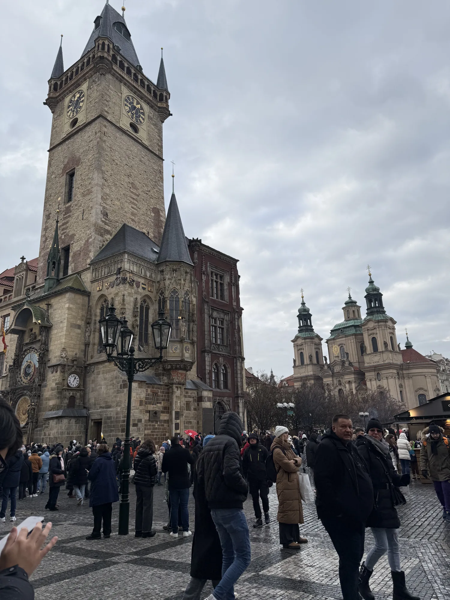 Old Town Hall tower above a busy Prague square