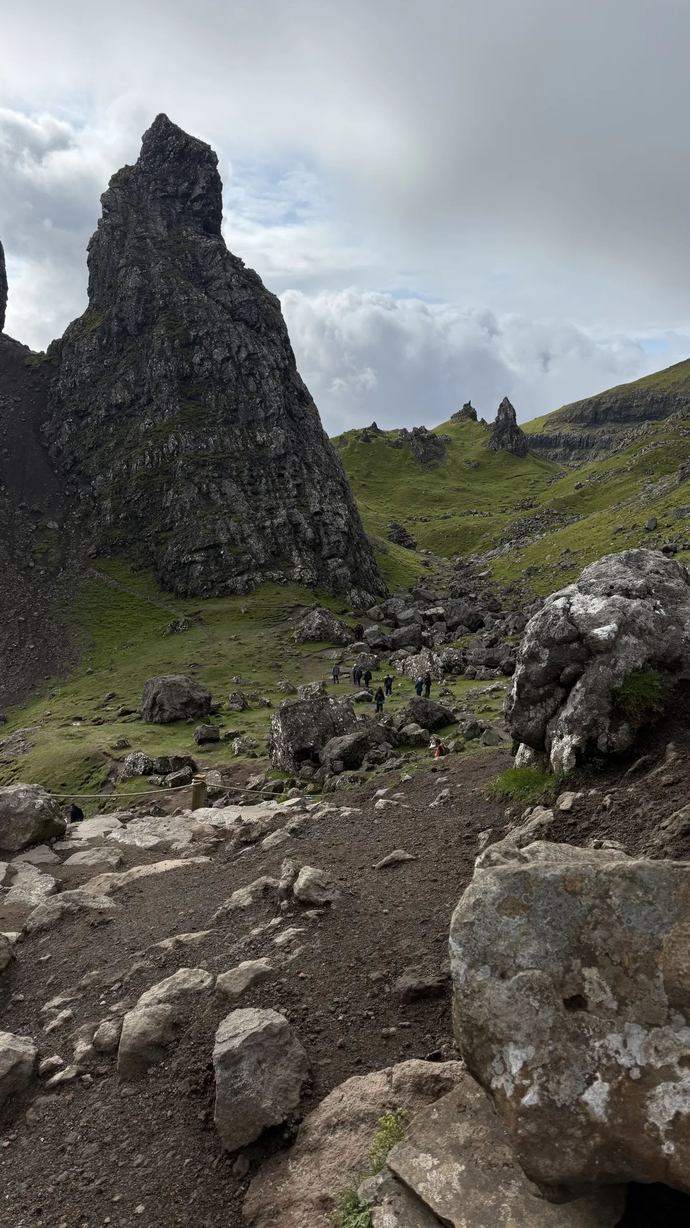 Rocky walking path beside a Storr pinnacle on Skye