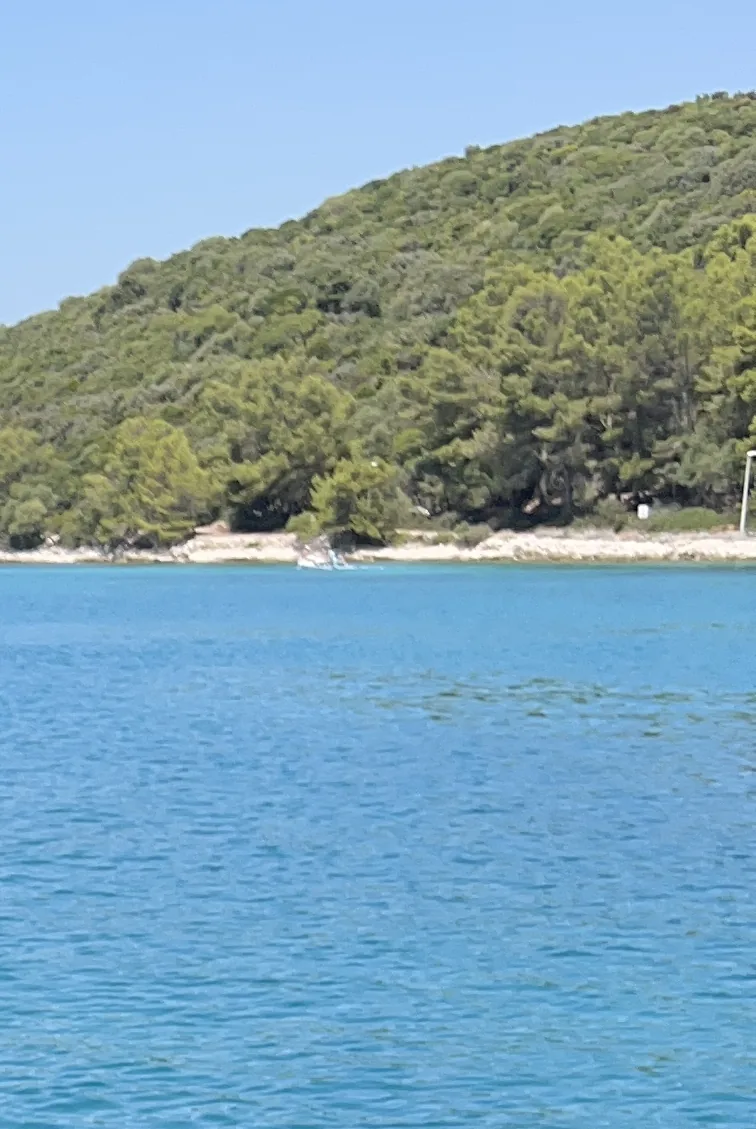 Blue water and wooded shoreline in the Lumbarda photo archive