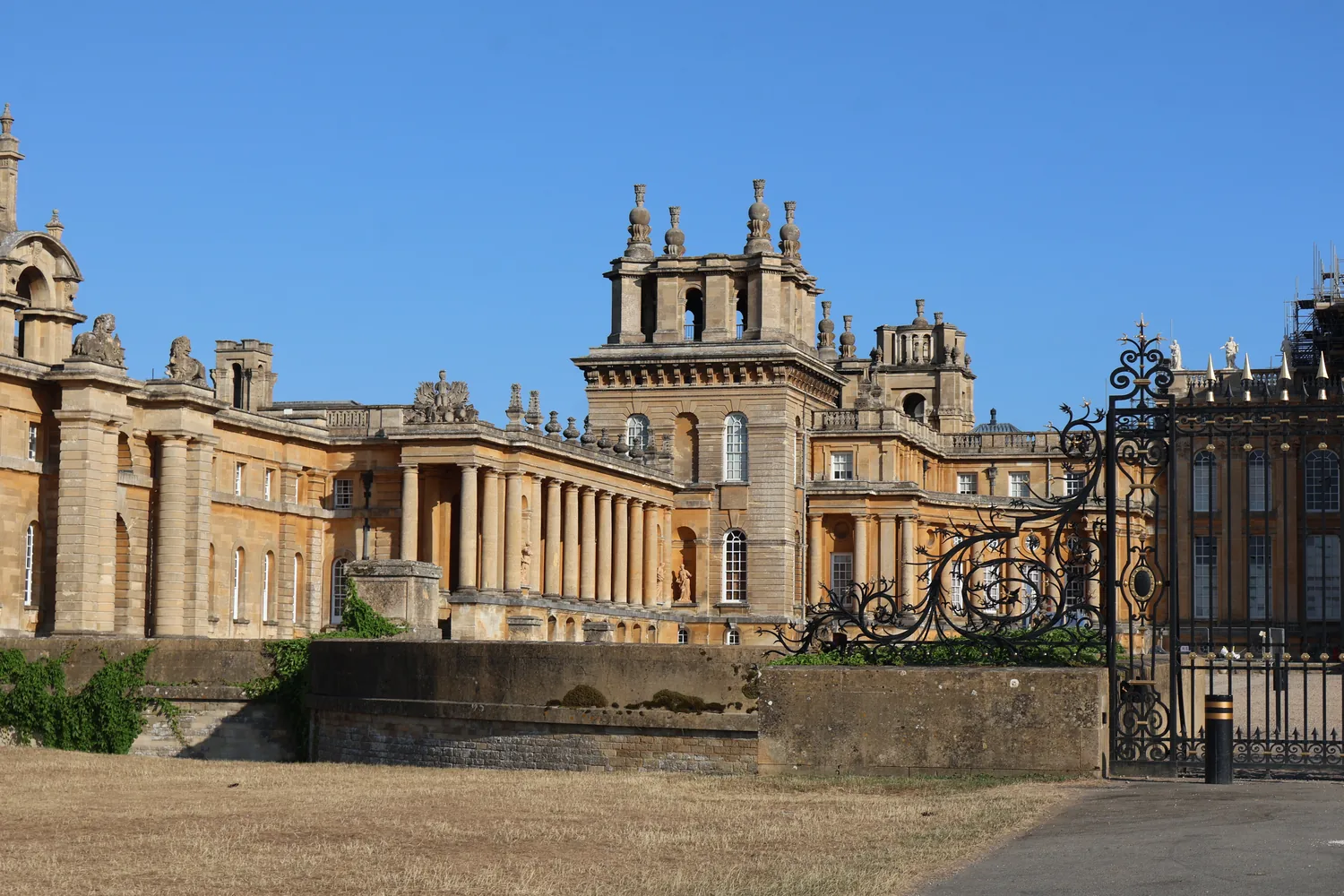Blenheim Palace’s stone façade beneath a clear sky, photographed from the grounds.