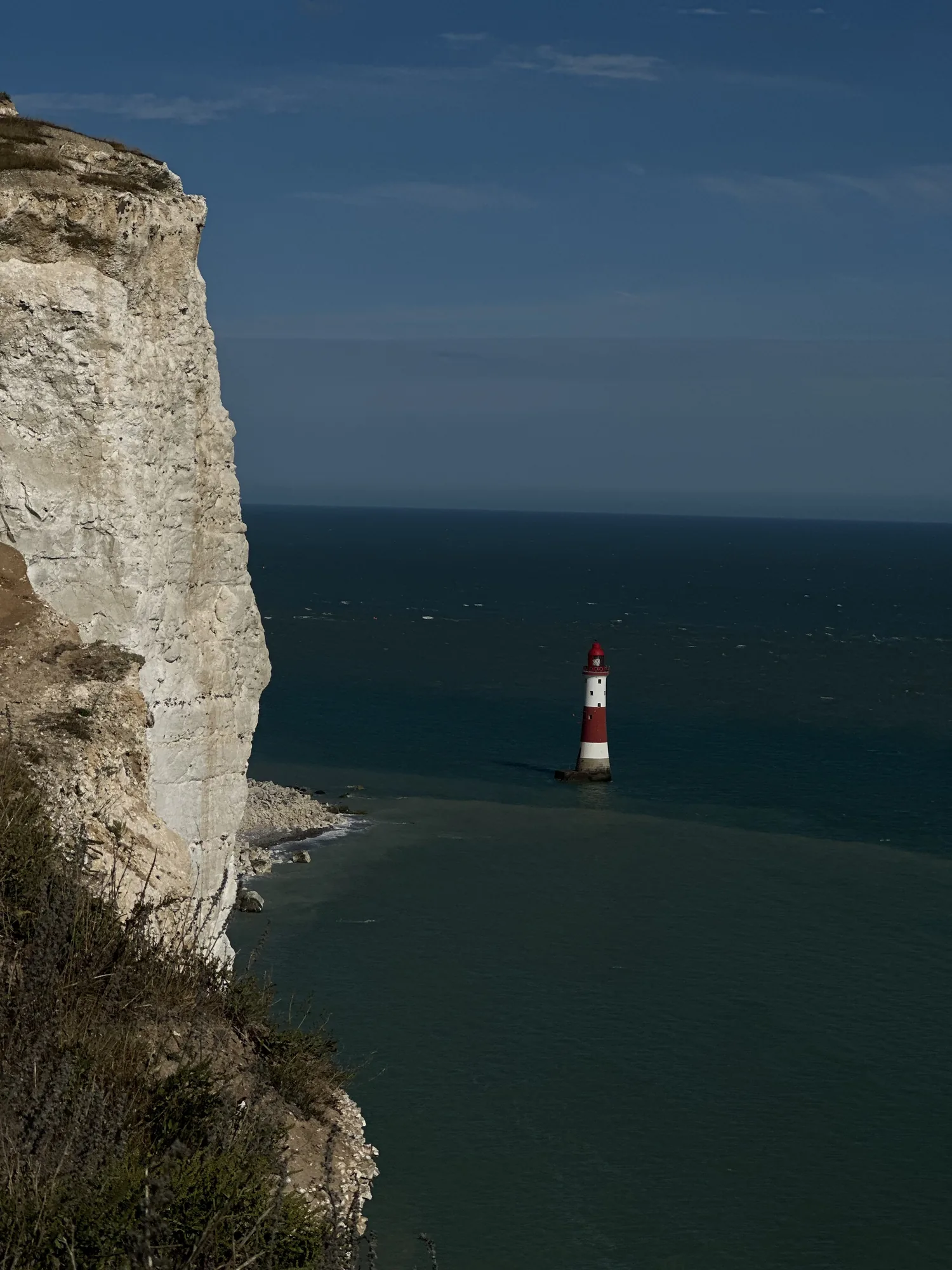 Beachy Head’s red-and-white lighthouse beneath the chalk cliffs.