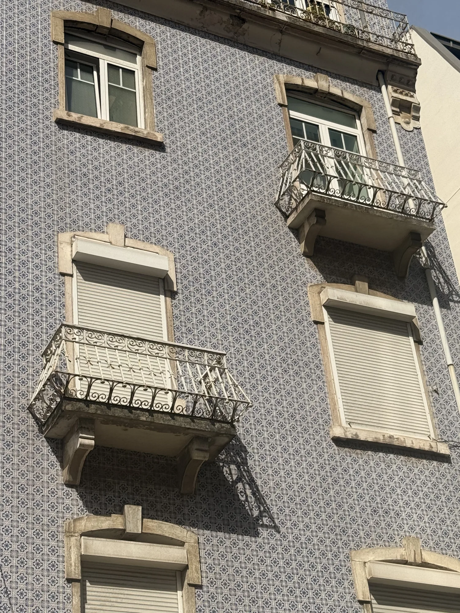 Lisbon facade covered in small tiles with projecting balconies
