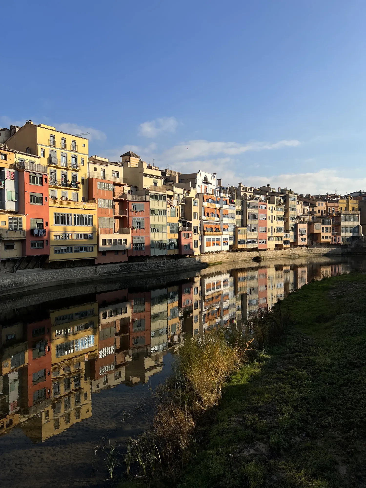 Colourful Girona houses reflected in the River Onyar