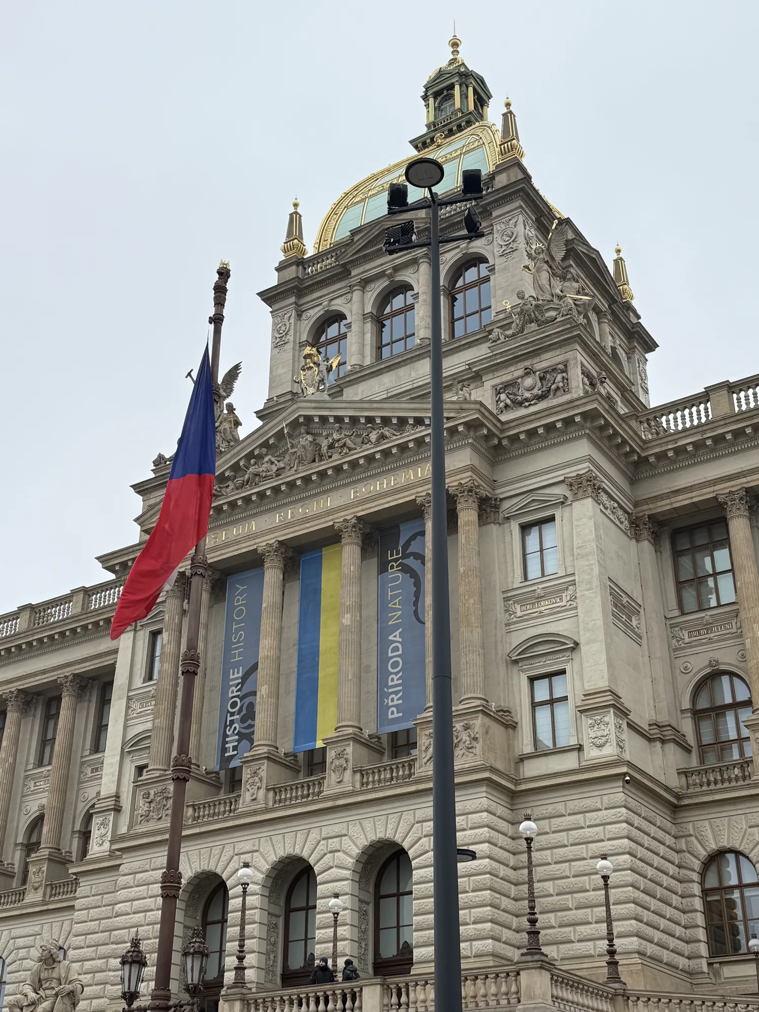 Stone facade and flags at Prague Municipal House