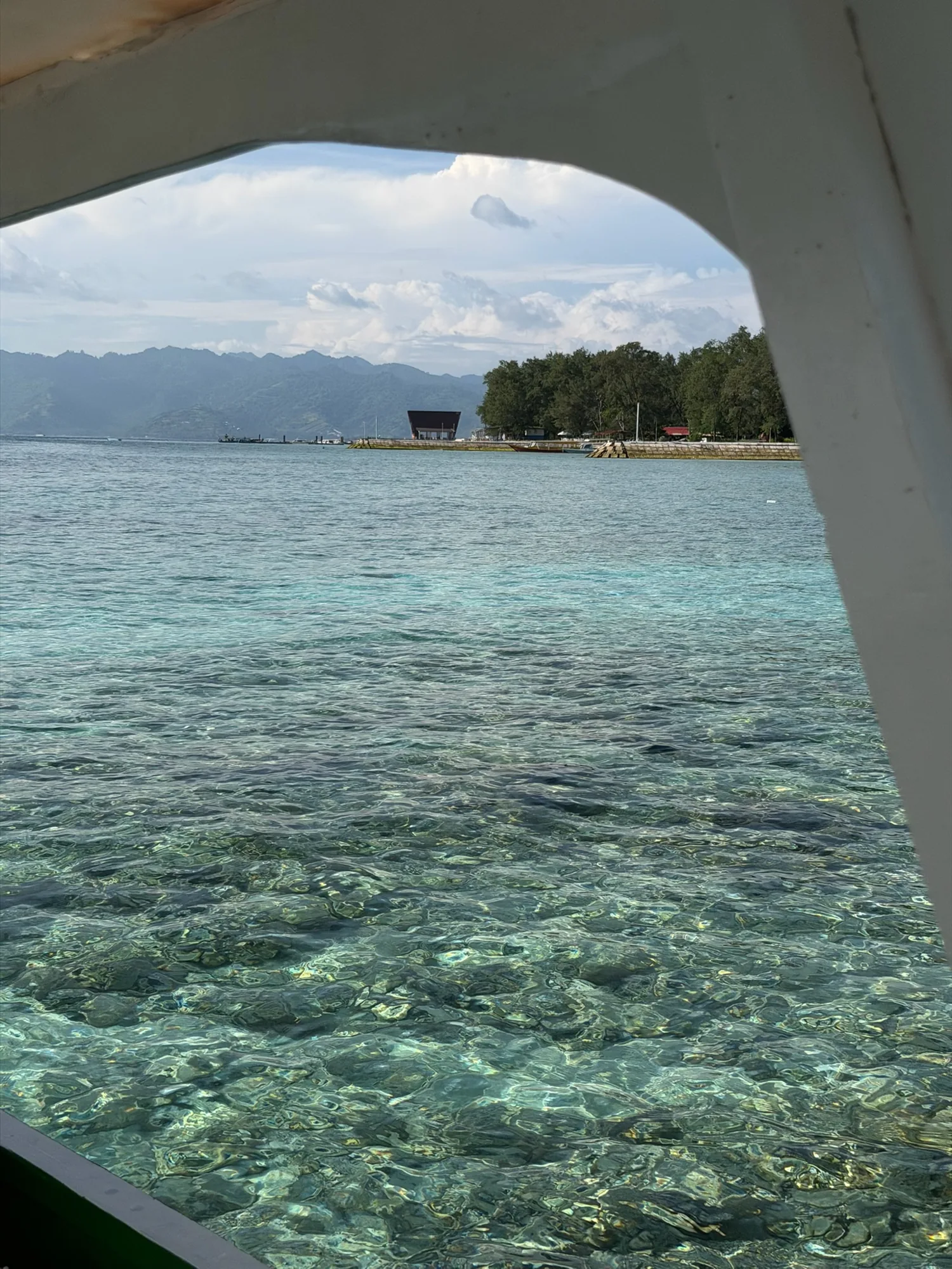 Clear Gili Islands shallows photographed through a boat opening